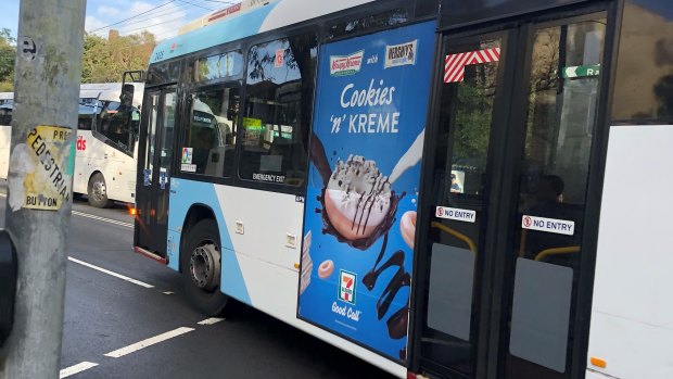A junk food ad on the side of a bus in Randwick.
