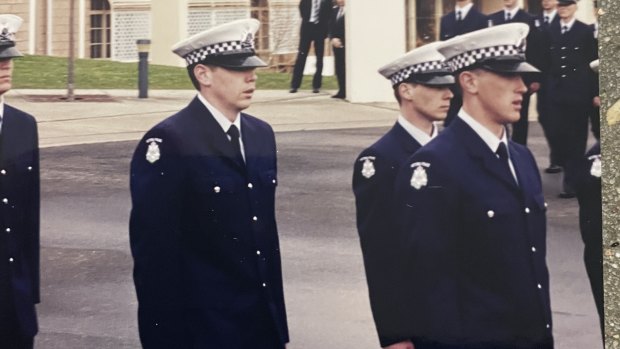 Tim Peck (middle) graduates from the Police Academy.