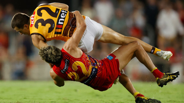 In his grasp: Hawthorn’s Finn Maginness is tackled by Izak Rankine.