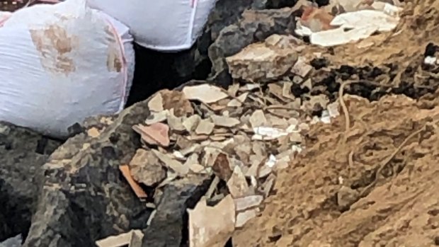 Asbestos and other building waste has been unearthed along Wamberal beach following severe erosion.