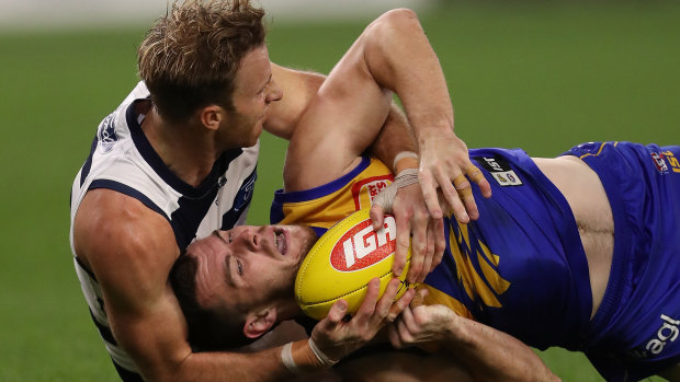 Rough and tumble: Geelong's Lachie Henderson tackles West Coast's Luke Shuey.