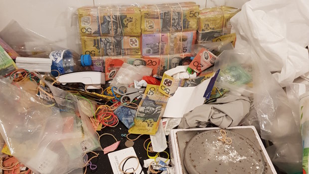 A supplied image of part of the $1.56 million dollars in cash seized by police during a house raid in New Farm on Monday.