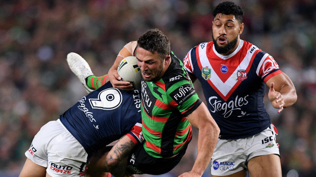 Committed: Sam Burgess is driven back by the Roosters' busy rake Jake Friend.