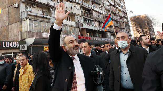 Armenian Prime Minister Nikol Pashinyan waves to supporters during a rally.