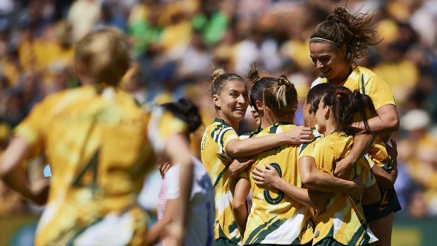 Prolific: The Matildas gather around Sam Kerr after she struck against Chile.