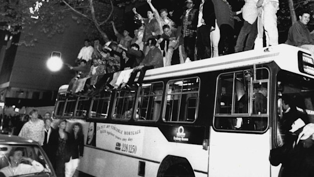 Sydneysiders celebrate on top of a bus in George Street after the announcement in Monte Carlo. September 24, 1993. 