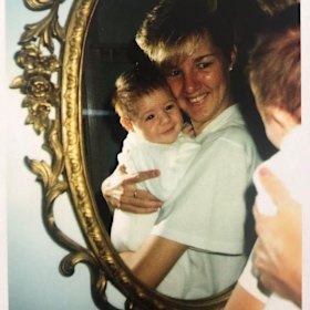 Sam Naismith being held by his sister Kristi as a baby.