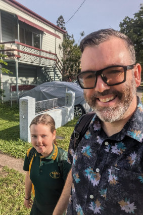 East Brisbane State School parent Daniel Angus, with his daughter Sadie, walking to school earlier this year.