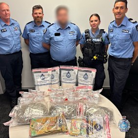 Officers stand with the items seized.