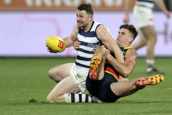 Patrick Dangerfield is intercepted by Ben Keays during the Wildcats' win over Adelaide.