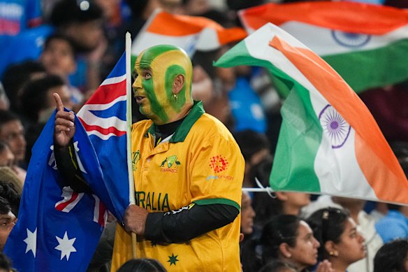 An Australian fan cheers on his side.