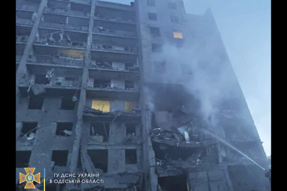 First responders try to extinguish flames at a residential building in Odesa, Ukraine, early on Friday, following Russian missile attacks.