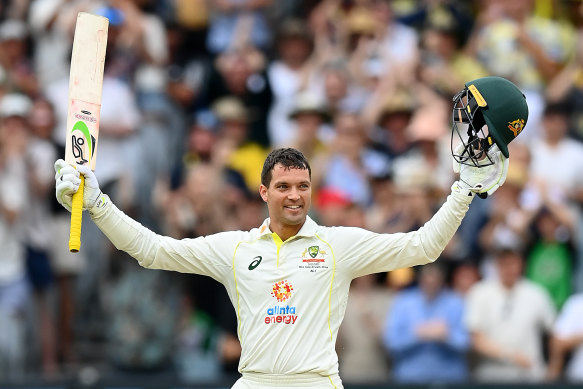 Alex Carey celebrates his century.
