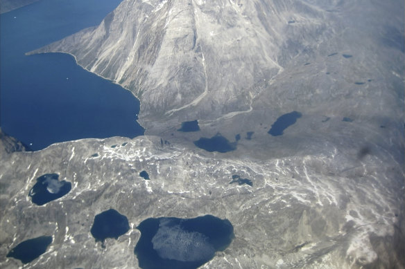An aerial view of melt-water lakes on the edge of an ice cap in Nunatarssuk, Greenland, taken on June 22.