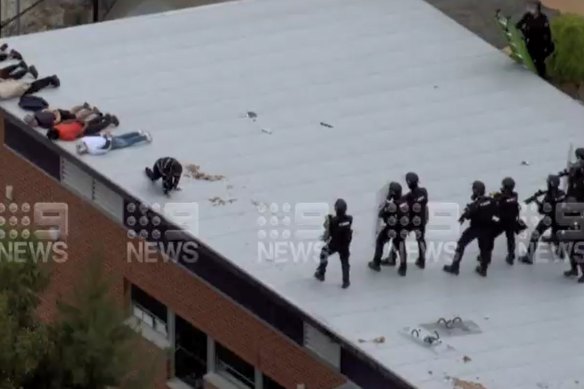 Officers storming the Banksia Hill Detention Centre rooftop on Wednesday. 