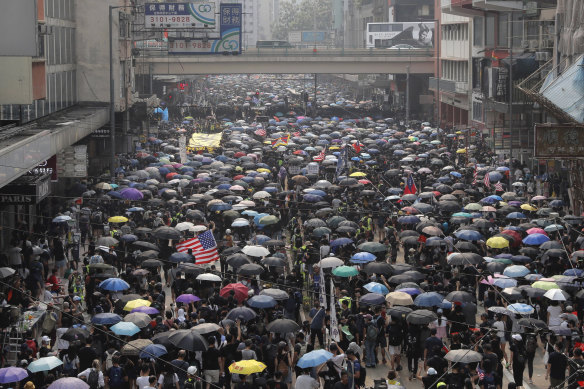 Protesters march in Hong Kong on Sunday.