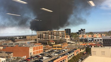 Smoke from a factory fire in Sydney's south-west has blanketed the sky. 