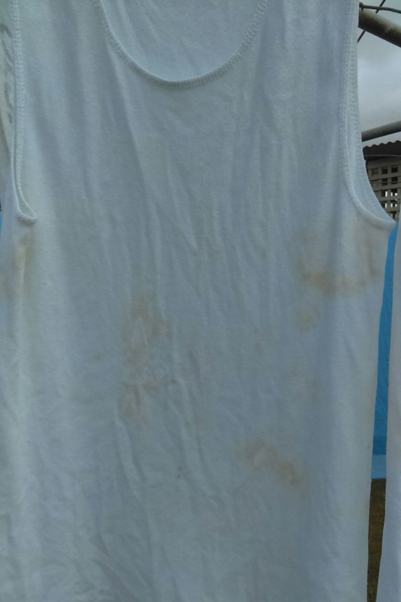 A white singlet stained after washing.