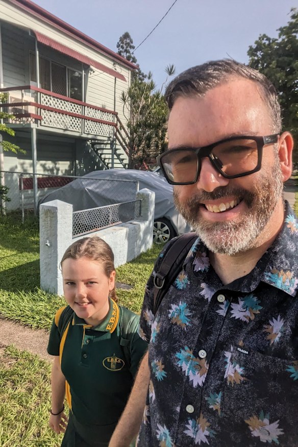 East Brisbane State School parent Daniel Angus, with his daughter Sadie, walking to school earlier this year.