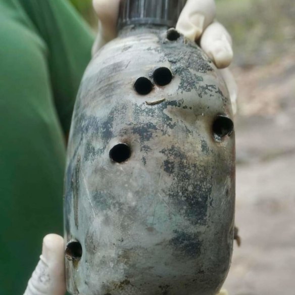 A water bottle with bullet holes found at the mass grave of North Vietnamese soldiers killed at the Battle of Balmoral.