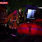 Authorities say the driver was rescued by being pulled from his vehicle by his hair.