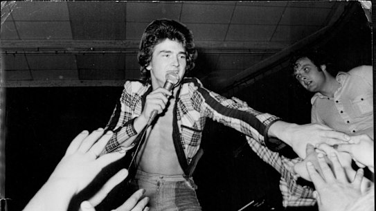 Hands reach out to the open-shirted Bay City Roller Leslie McKeown during last night's performance. December 04, 1975.