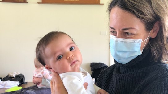 The writer with her baby, then 10 weeks’ old: “Sometimes, my daughter finds an old photo of me wearing a mask, and, being an inquisitive Miss Nearly-Five, has questions.”