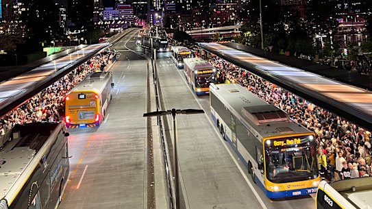Crowds wait for buses after Riverfire 2025 in Brisbane.
