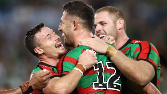 Destructive force: The Bunnies gather around Sam Burgess after he scored against Brisbane.