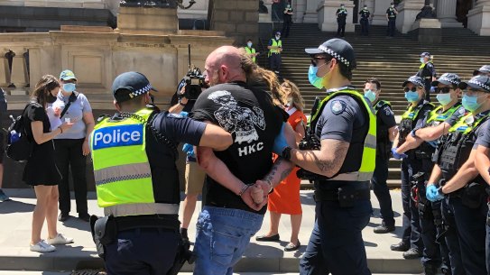 Police arrest a man at an anti-lockdown protest outside Victoria's Parliament House on November 3.