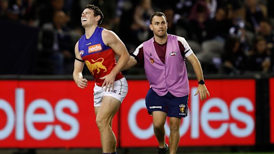 MELBOURNE, AUSTRALIA - APRIL 24: Lachie Neale of the Lions winces in pain during the round six AFL match between the Carlton Blues and the Brisbane Lions at Marvel Stadium on April 24, 2021 in Melbourne, Australia. (Photo by Darrian Traynor/Getty Images)