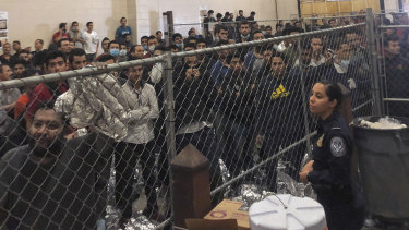 Male asylum seekers stand in a packed detention center in McAllen, Texas, earlier this month.