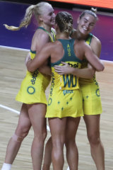 Australia's players congratulate each other after winning their Netball World Cup semifinal.