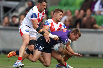 Cameron Munster is tackled by Zac Lomax and Jack Bird at AAMI Park.