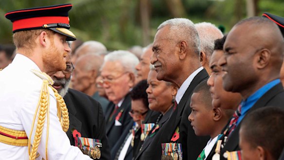 Britain's Prince Harry meets a number of Fijian war veterans at a ceremony at the Suva War Memorial in Suva, Fiji.