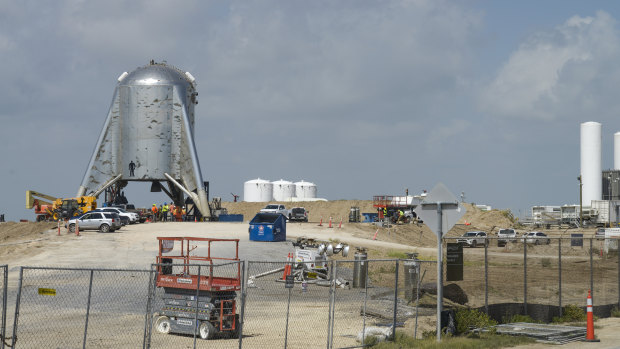 Crews working around SpaceX's Starhopper rocket at the company's launch facility.