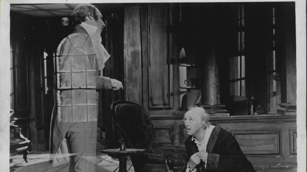 Alistair Sim, right, as Scrooge in A <i> A Christmas Carol</i> (1952).