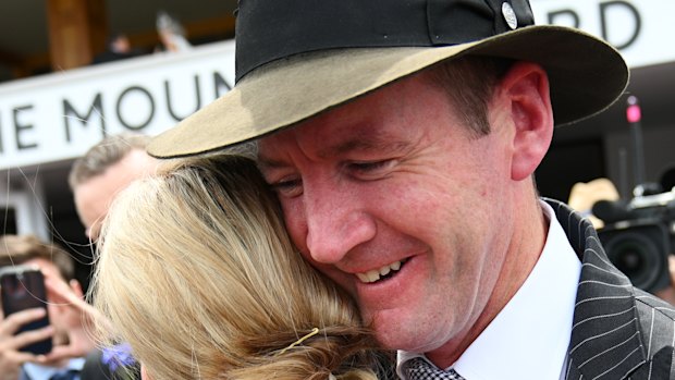 Ciaron Maher hugs Jamie Kah after winning a race for the late Colin McKenna on Victoria Derby Day.