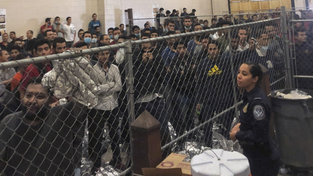 Male asylum seekers stand in a packed detention center in McAllen, Texas, earlier this month.