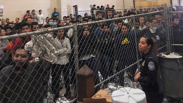 Male asylum seekers stand in a packed detention center in McAllen, Texas, earlier this month.