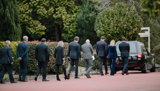 Mourners follow David Leckie’s hearse at his low key funeral on Friday.