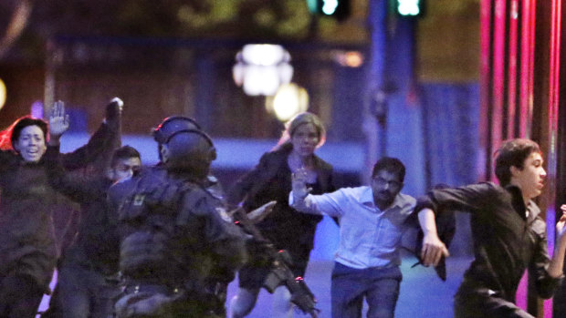 Hostages run from the Lindt Cafe towards Special Operations police on December 16, 2014.