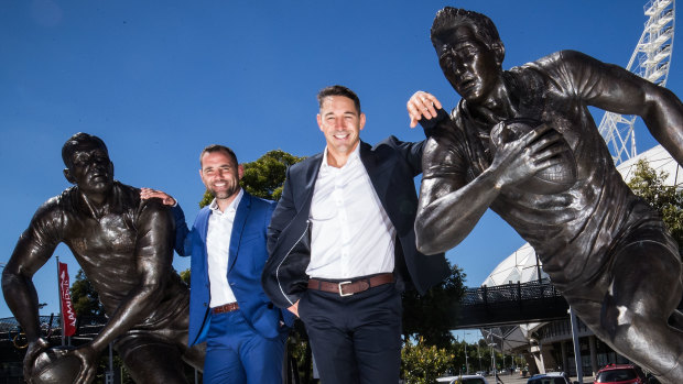 Storm legends Cameron Smith and Billy Slater poses for a photo with their statues at AAMI Park on Wednesday.