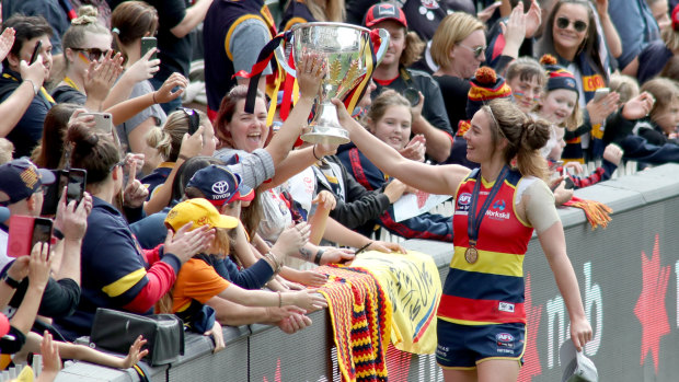 Jenna McCormick celebrates Adelaide's AFLW flag in March.