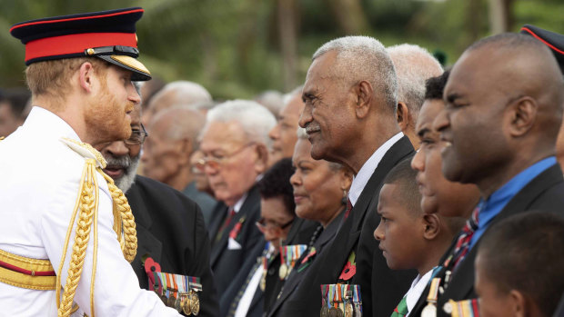 Britain's Prince Harry meets a number of Fijian war veterans at a ceremony at the Suva War Memorial in Suva, Fiji.