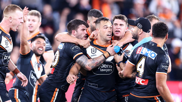 Luke Brooks is mobbed by teammates after kicking the winning field goal against the Rabbitohs last weekend.