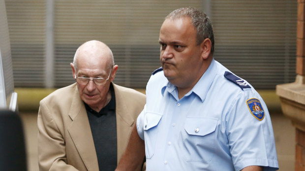 Roger Rogerson, left, is escorted out of Sydney's King Street courts during his trial for murder, June 2016.