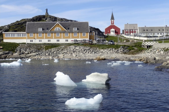 Small pieces of ice float off the shore in Nuuk, Greenland, last month, as the heatwave in Europe prompted fears, now realised, of a massive ice melting event.