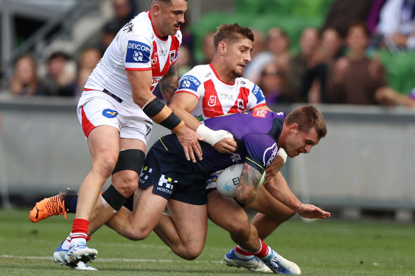 Cameron Munster is tackled by Zac Lomax and Jack Bird at AAMI Park.