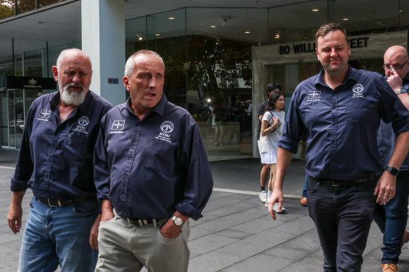 Rail Tram and Bus Union state secretary Toby Warnes (right) and other officials leave the Fair Work Commission on Tuesday.